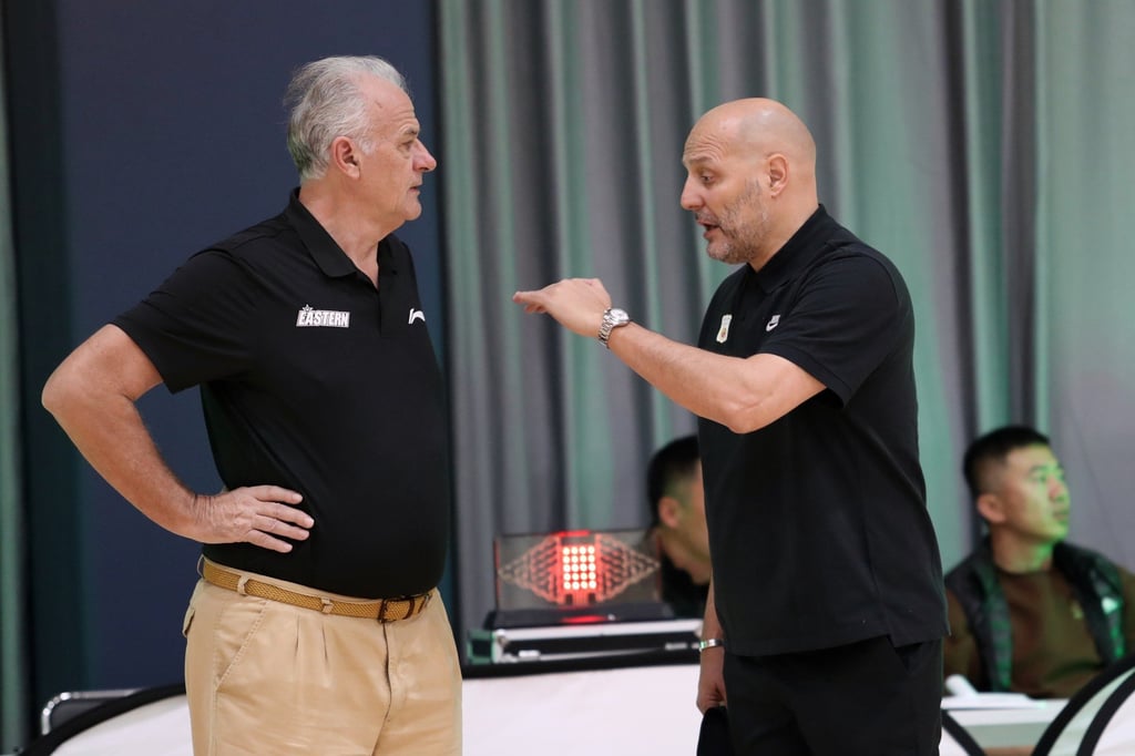 Hong Kong Eastern head coach Zeljko Pavlicevic (left) talking to compatriot Aleksandar Dordevic before a game against China’s basketball team in Qingdao. Photo: Mike Chan