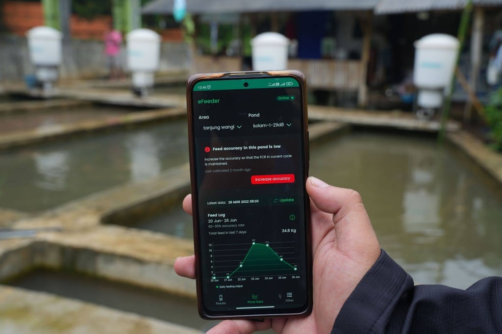 The eFeeder app on a smartphone at a fish farm in West Java, Indonesia. Fish-feeding firm eFishery provides farmers with a dispenser that scatters pellets based on data from thousands of users. Photo: Bloomberg The eFeeder app on a smartphone at a fish farm in West Java, Indonesia. Fish-feeding firm eFishery provides farmers with a dispenser that scatters pellets based on data from thousands of users. Photo: Bloomberg