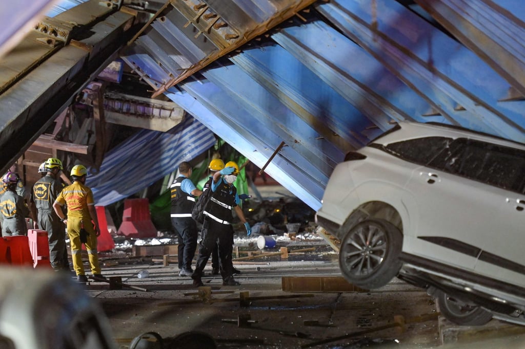 Forensic police and rescuers inspect the scene after the girder collapsed, killing at least one person. Photo: AFP