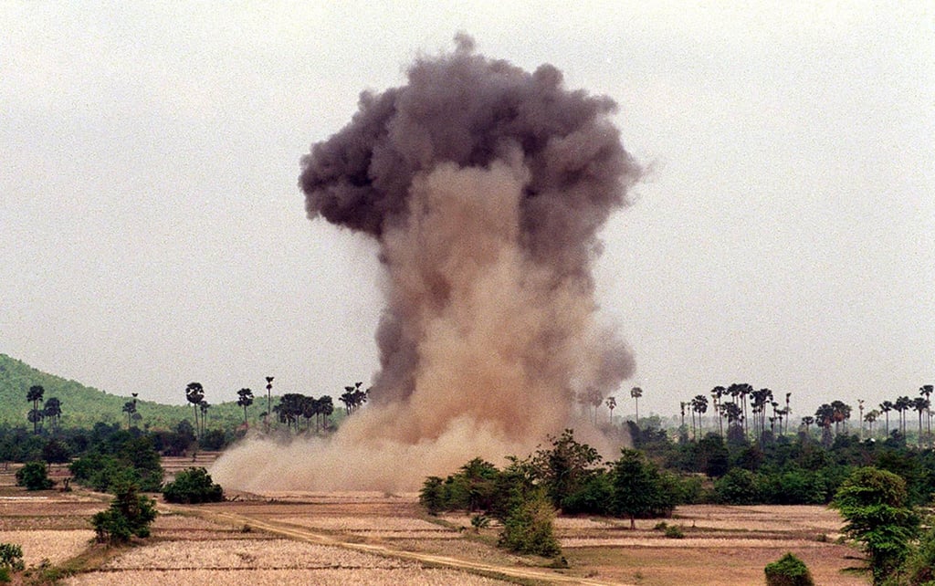 A cloud of dust and smoke rises from a cache of unexploded ordinance detonated by deminers in Cambodia in 2004. The country’s government has vowed to clear all mines and unexploded ordnance by 2025. Photo: AFP A cloud of dust and smoke rises from a cache of unexploded ordinance detonated by deminers in Cambodia in 2004. The country’s government has vowed to clear all mines and unexploded ordnance by 2025. Photo: AFP
