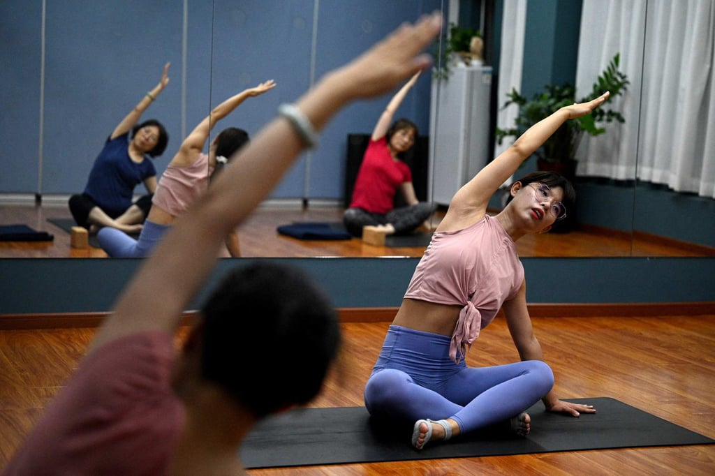 A yoga instructor teaches at a gym in Beijing’s middle-class neighbourhood of Shangdi. Photo: AFP
