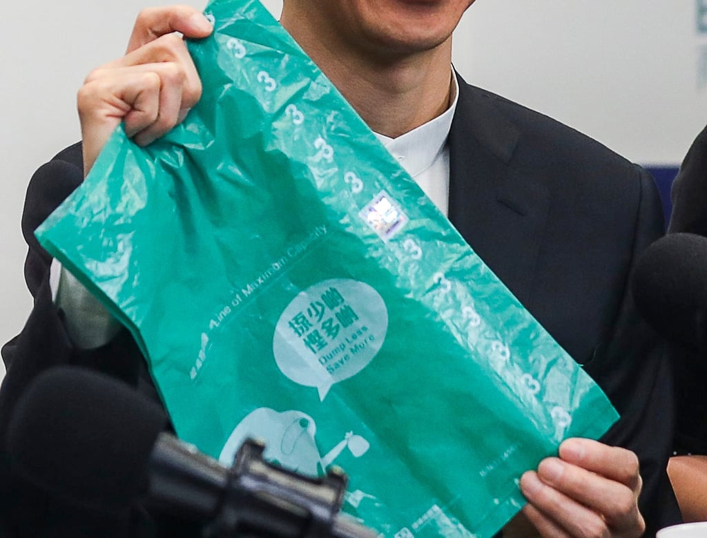 Then environment chief Wong Kam-sing displays a government-designated garbage bag in 2018. Photo: Xiaomei Chen