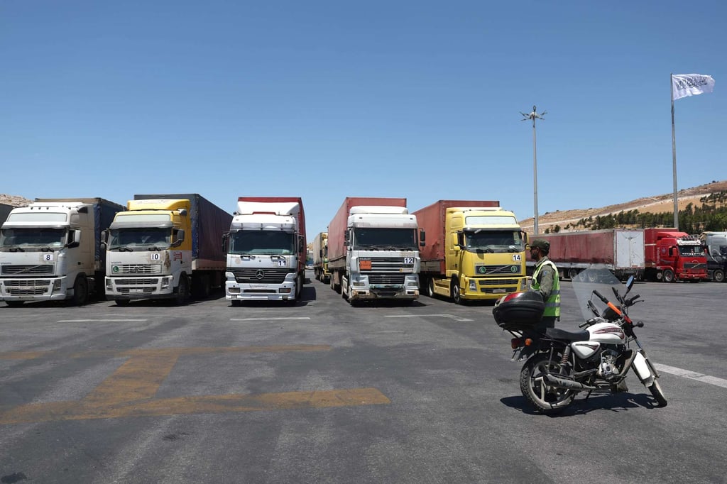 A convoy of trucks carrying humanitarian aid parked after crossing the Syrian Bab al-Hawa border crossing with Turkey. Photo: AFP