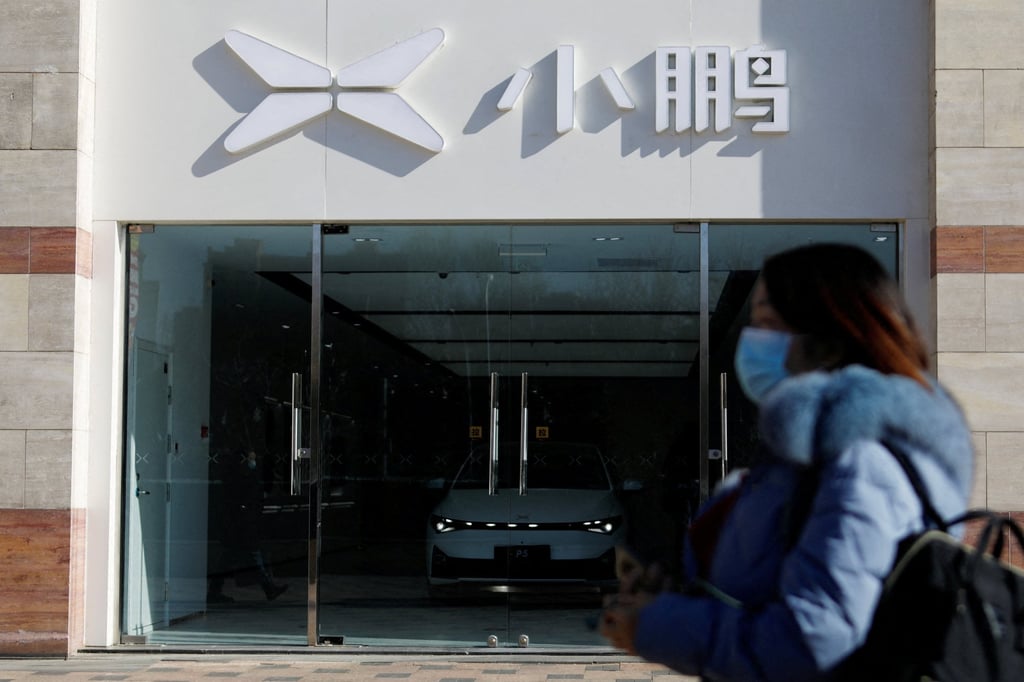 A woman walks past a showroom of Chinese electric vehicle (EV) maker Xpeng in Beijing on February 4, 2023. Photo: Reuters