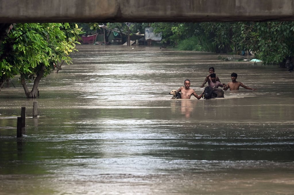 Deadly floods amid record monsoon rains kill at least 100 people in ...