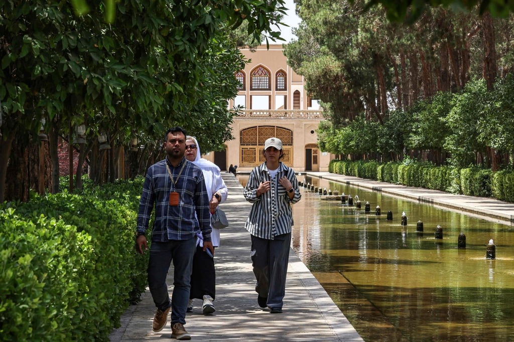 A guide leads tourists at the Dowlat Abad Garden in Iran’s central city of Yazd. Photo: AFP
