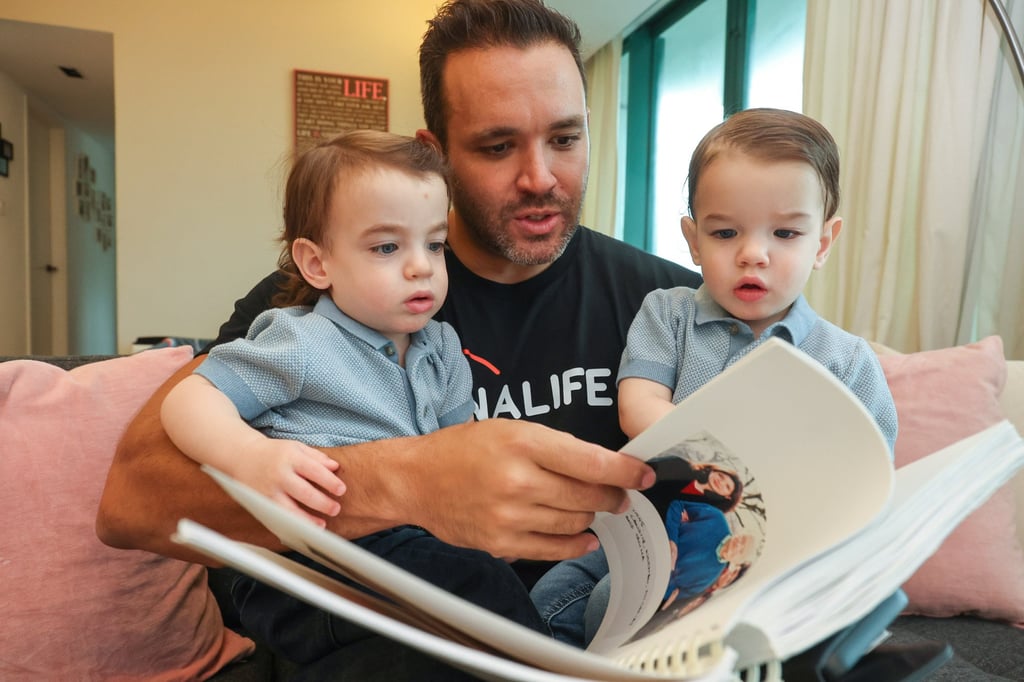 Nicholas Worley tells his twins Kai (left) and Kaleb about their family at their home in Discovery Bay. Photo: Edmond So