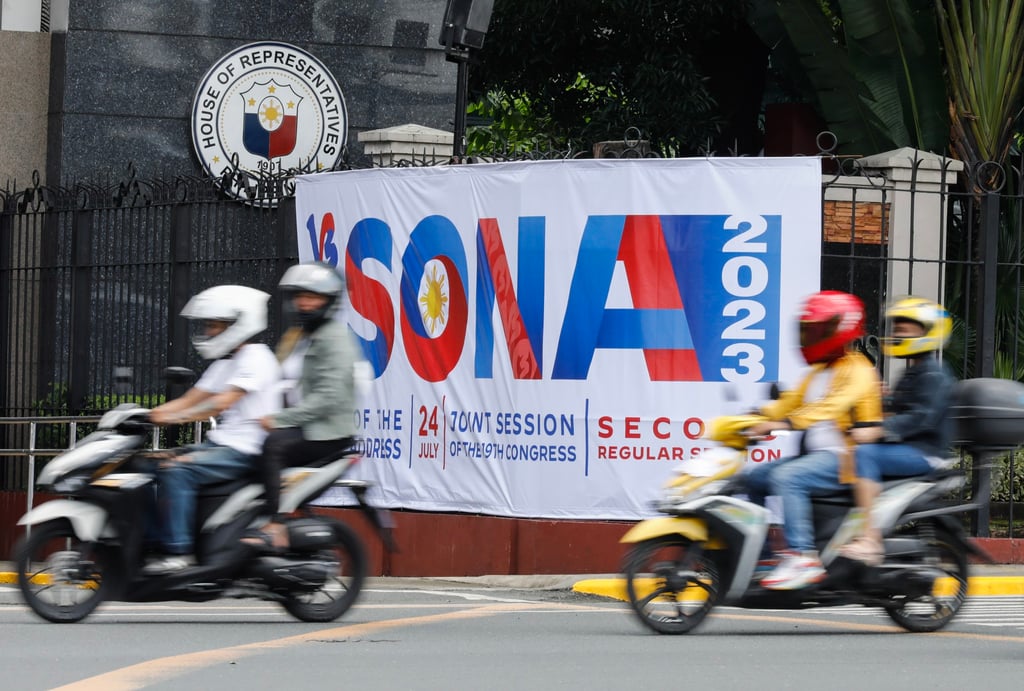 People ride past a banner announcing the coming State of the Nation Address of Philippine President Ferdinand Marcos Jnr, outside the House of Representatives in Quezon City, Metro Manila on Saturday. Photo: EPA-EFE