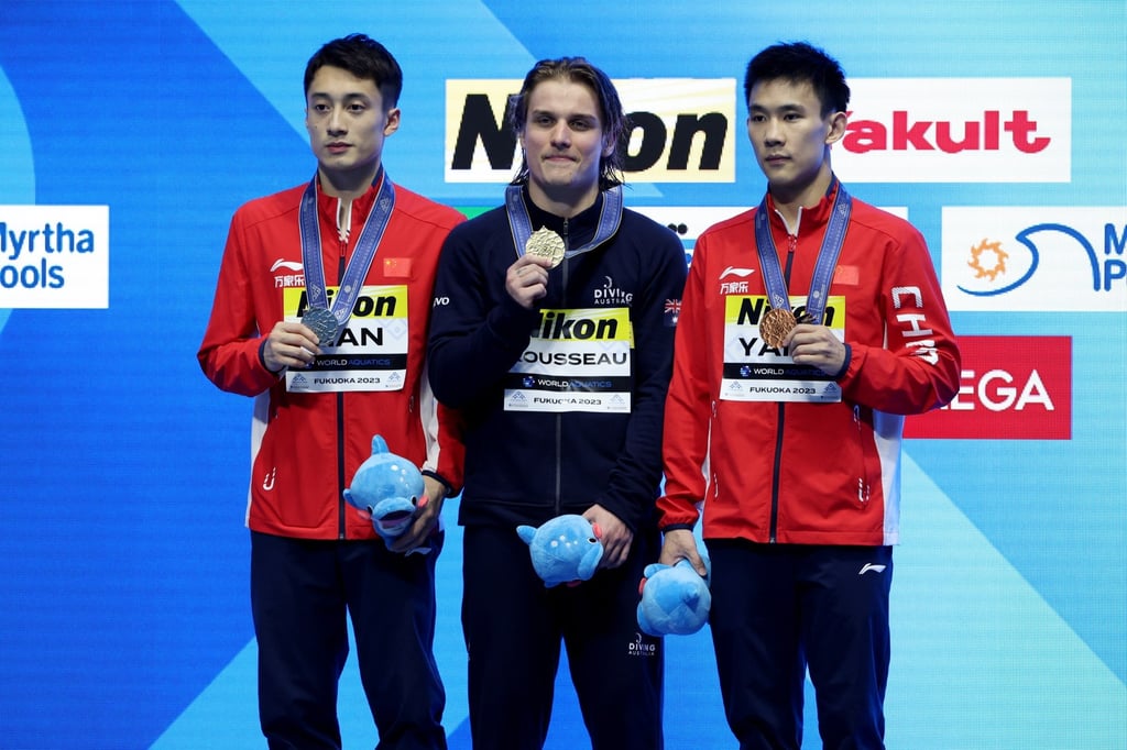 Gold medallist Cassiel Rousseau is flanked by Lian Junjie, who won silver, Yang Hao, who took bronze. Photo: EPA-EFE