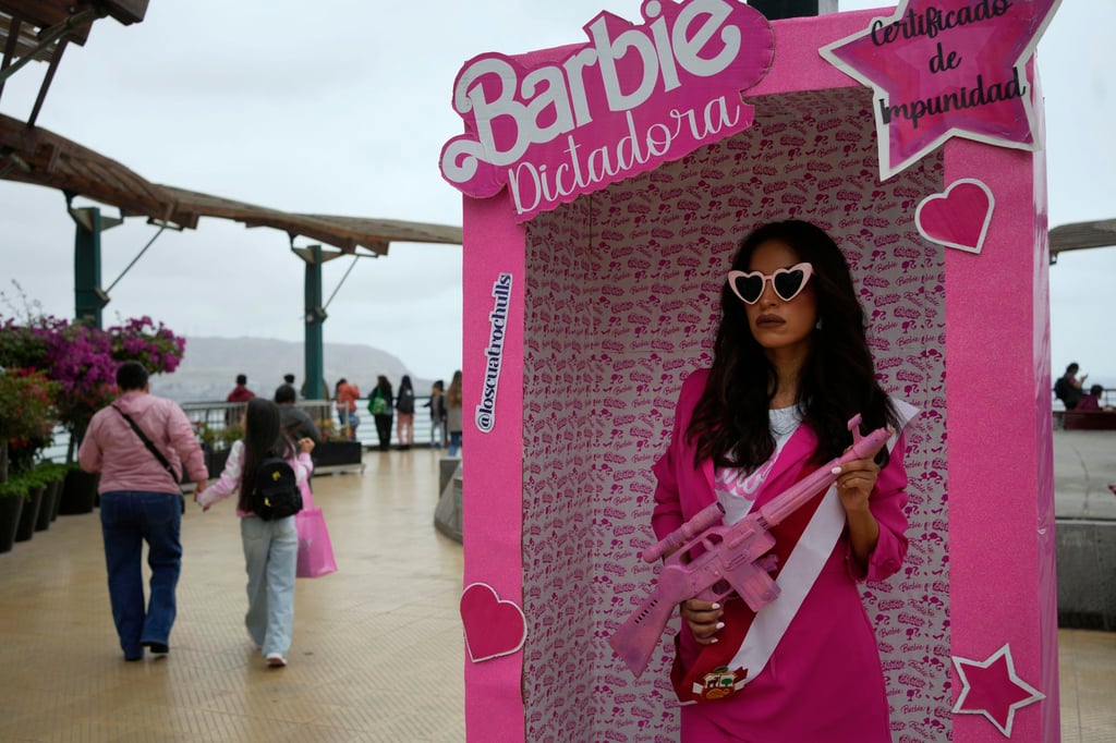 An anti-government protester, dressed as Barbie holding a fake gun, takes part in a demonstration against Peruvian President Dina Boluarte in Lima, Peru, on Saturday. Photo: AP