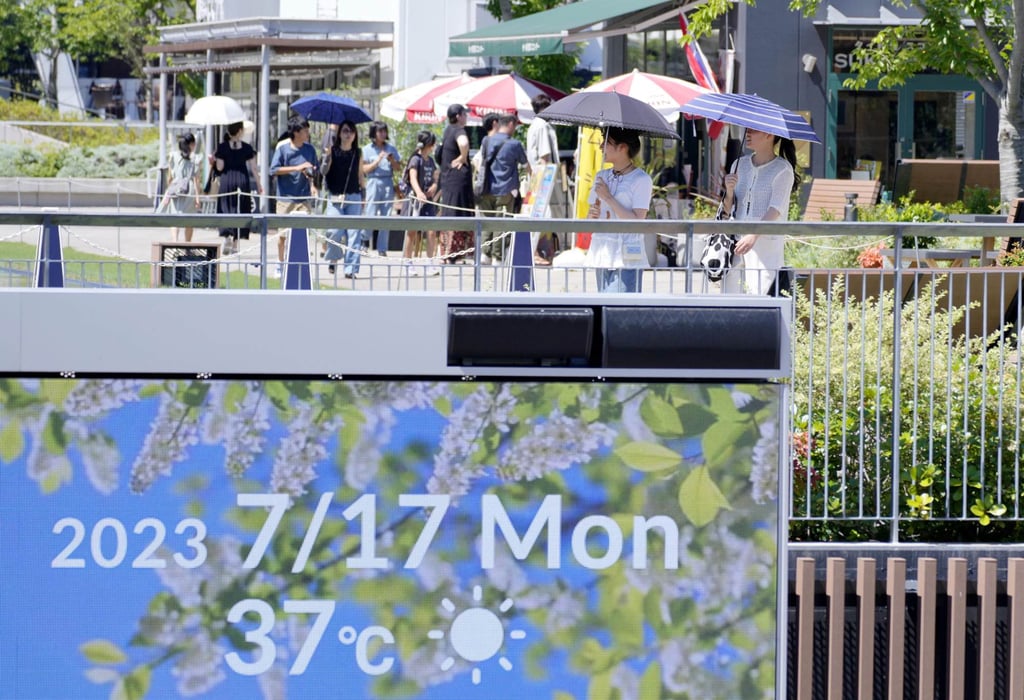 People walk with parasols on a sweltering day in the central Japanese city of Nagoya last week. Photo: Kyodo People walk with parasols on a sweltering day in the central Japanese city of Nagoya last week. Photo: Kyodo