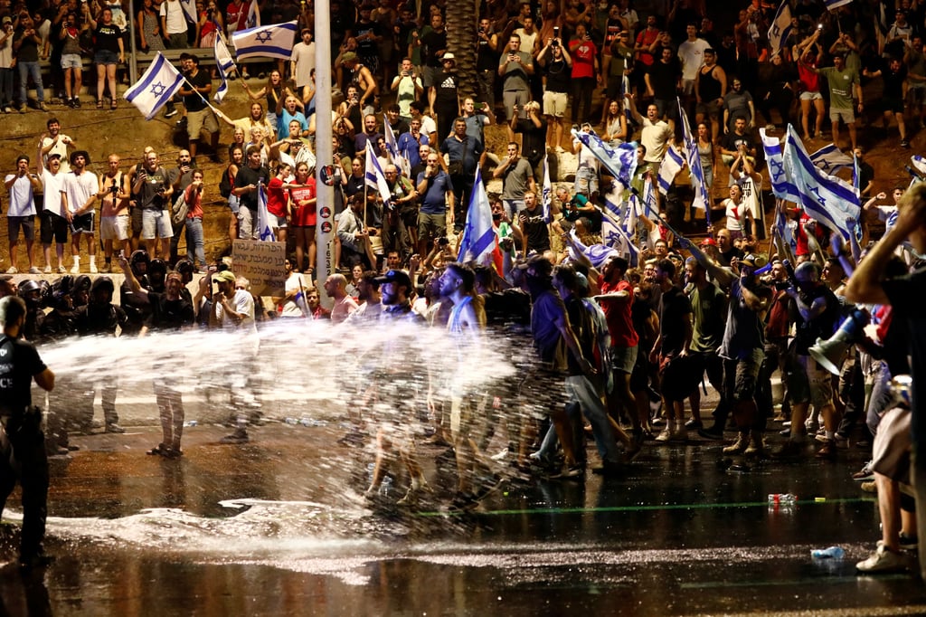 Police use water cannon as protesters block Ayalon Highway in Tel Aviv, Israel on Monday. Photo: Reuters