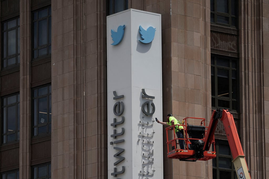 A worker dismantles Twitter’s sign at its corporate headquarters as CEO Elon Musk renamed the platform as X and unveiled a new logo. Photo: Reuters A worker dismantles Twitter’s sign at its corporate headquarters as CEO Elon Musk renamed the platform as X and unveiled a new logo. Photo: Reuters