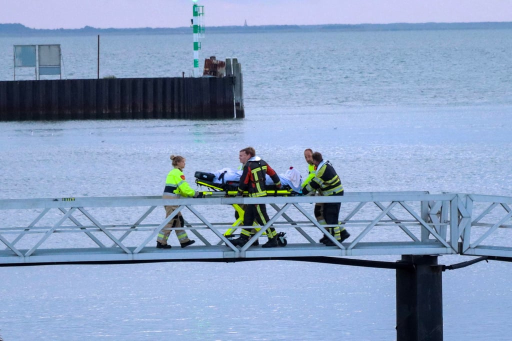 Emergency services bring a crew member ashore in Lauwersoog, the Netherlands. Photo: EPA-EFE Emergency services bring a crew member ashore in Lauwersoog, the Netherlands. Photo: EPA-EFE