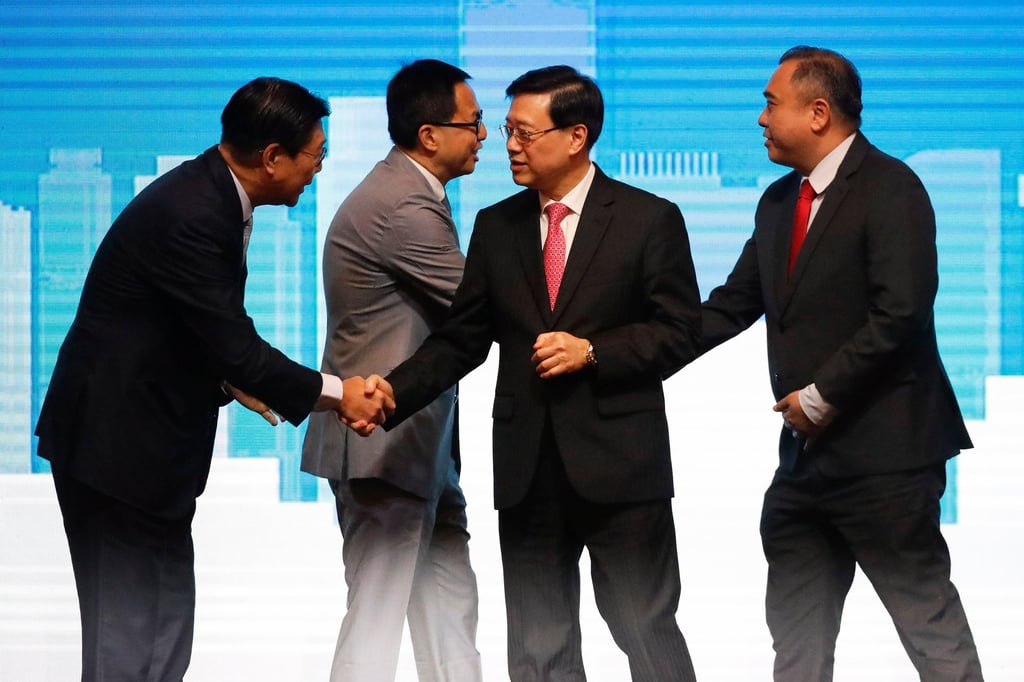 Hong Kong leader John Lee (second right) and Malaysian transport minister Anthony Loke (right) shake hands with other participants at Friday’s business lunch. Photo: EPA-EFE Hong Kong leader John Lee (second right) and Malaysian transport minister Anthony Loke (right) shake hands with other participants at Friday’s business lunch. Photo: EPA-EFE