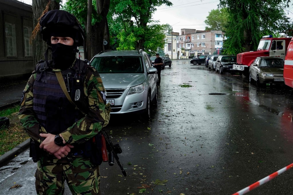 Law enforcement officers cordon off the site of an explosion in the southwestern Russian city of Taganrog on Friday. Photo: AFP Law enforcement officers cordon off the site of an explosion in the southwestern Russian city of Taganrog on Friday. Photo: AFP