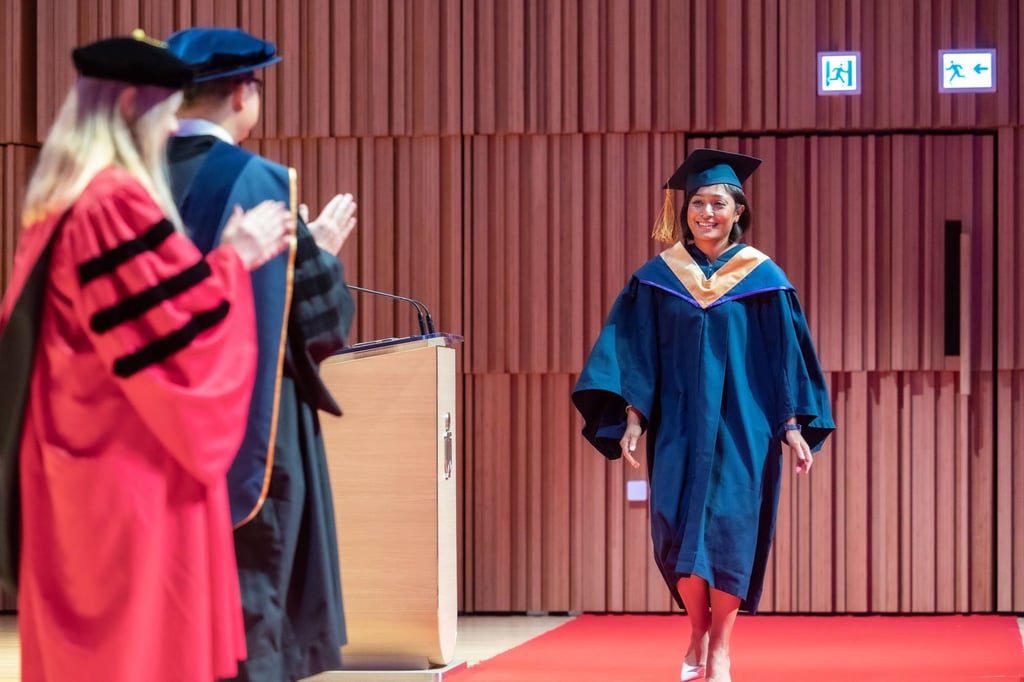 Su Yin Anand, a member of the Class of 2020, is applauded as she takes part in her graduation ceremony after completing her EMBA programme. Su Yin Anand, a member of the Class of 2020, is applauded as she takes part in her graduation ceremony after completing her EMBA programme.