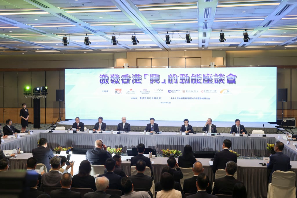 Chief Executive John Lee (centre); Zheng Yanxiong, the director of the central government’s liaison office in the city third from left) at a symposium designed to help boost the economy. Photo: Yik Yeung-man