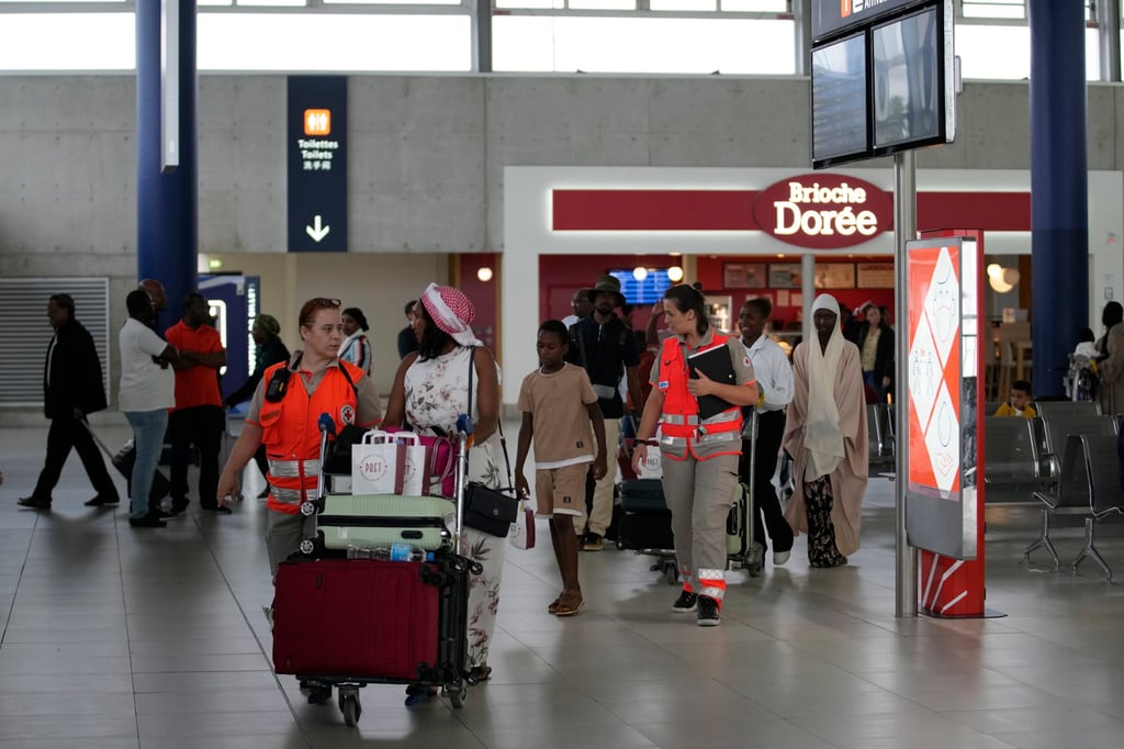 Red Cross workers take care of people evacuated from Niger at the Roissy Charles de Gaulle airport, north of Paris, in France on Wednesday. Photo: AP Red Cross workers take care of people evacuated from Niger at the Roissy Charles de Gaulle airport, north of Paris, in France on Wednesday. Photo: AP