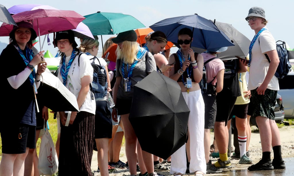 Attendees of the World Scout Jamboree hold umbrellas to avoid sunshine at a scout camping site in Buan, South Korea, on Friday. Photo: Yonhap via AP