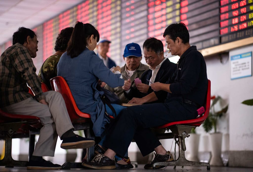 Investors play cards at a brokerage house in Shanghai in 2018. Photo: AFP Investors play cards at a brokerage house in Shanghai in 2018. Photo: AFP