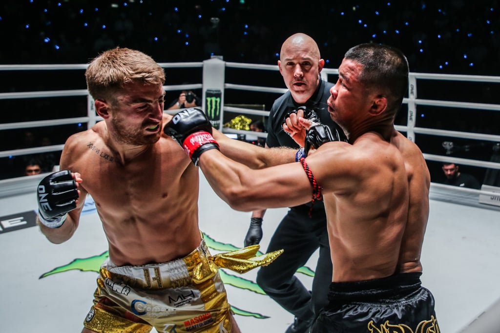 Jonathan Haggerty lands a left hook on Nong-O Hama at ONE Fight Night 9 in Bangkok before capturing the bantamweight Muay Thai title. Jonathan Haggerty lands a left hook on Nong-O Hama at ONE Fight Night 9 in Bangkok before capturing the bantamweight Muay Thai title.