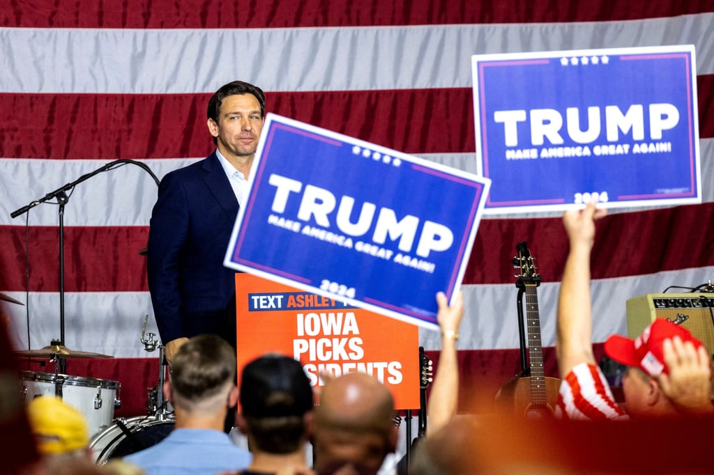 Republican US presidential candidate Ron DeSantis looks into the crowd as supporters of former president Donald Trump hold up signs during a fundraiser in Cedar Rapids, Iowa, on Sunday. Photo: USA Today Network via Reuters