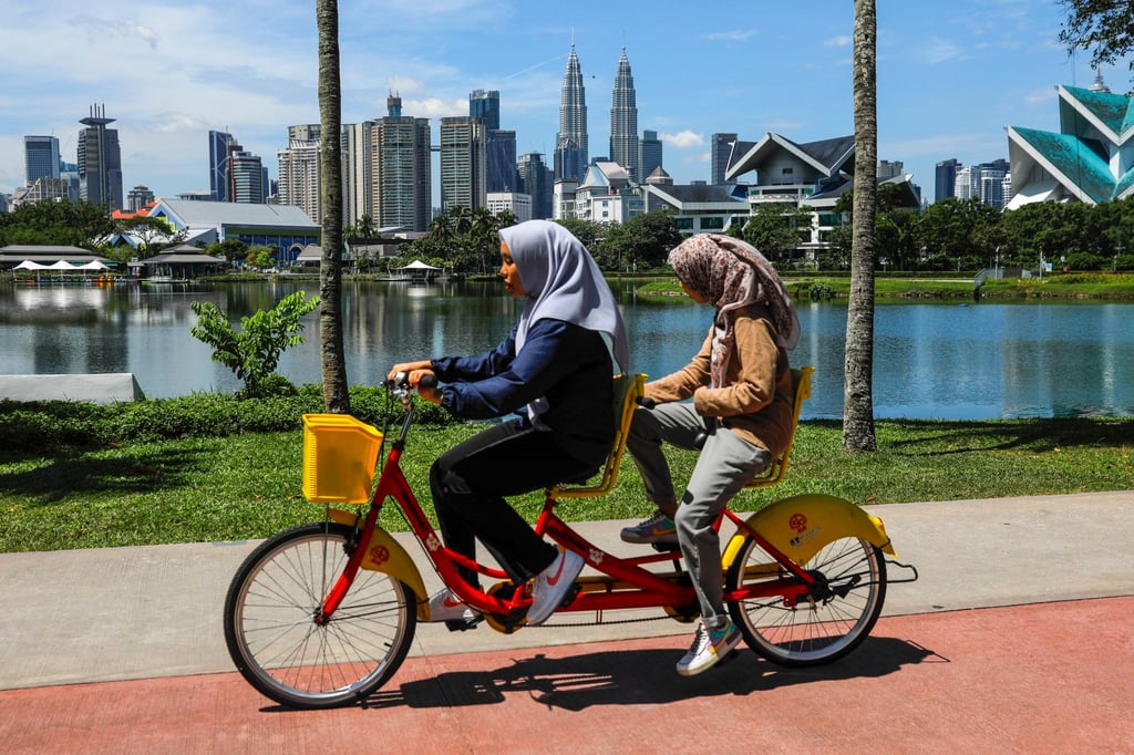 Women ride a tandem bicycle in Kuala Lumpur. While Malaysian social media users were jubilant over the news, many were appalled it took the victim going public and getting viral to be heard. Photo: EPA-EFE Women ride a tandem bicycle in Kuala Lumpur. While Malaysian social media users were jubilant over the news, many were appalled it took the victim going public and getting viral to be heard. Photo: EPA-EFE