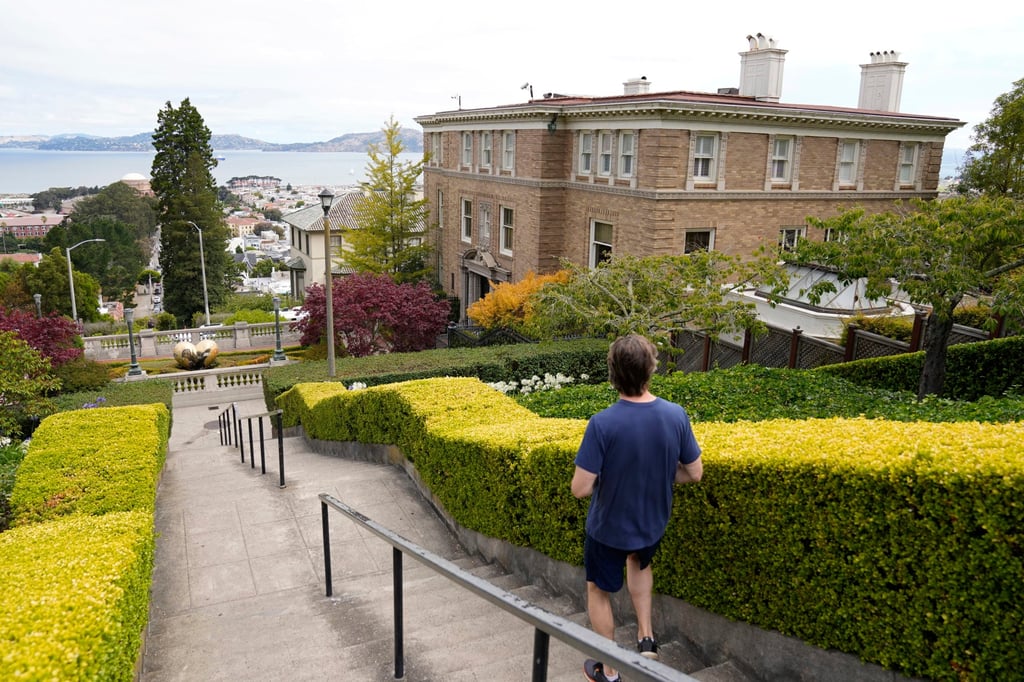 A jogger makes his way down steps outside the home of US Senator Dianne Feinstein in San Francisco on Wednesday. Photo: AP