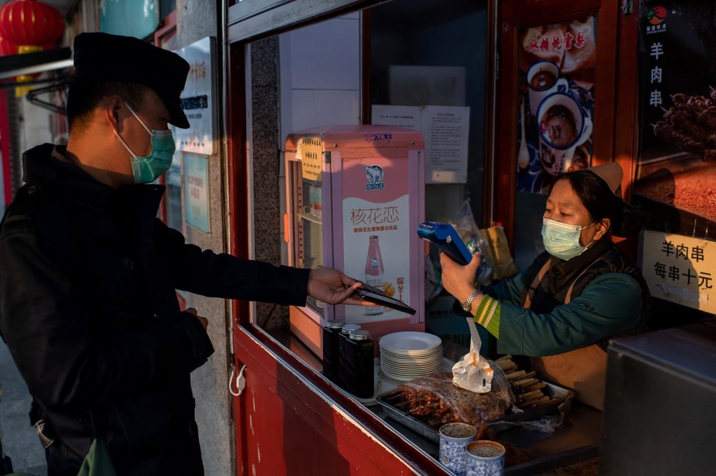 A customer makes an electronic Alipay payment on his smartphone to pay for his food at a restaurant in Beijing. Photo: AFP