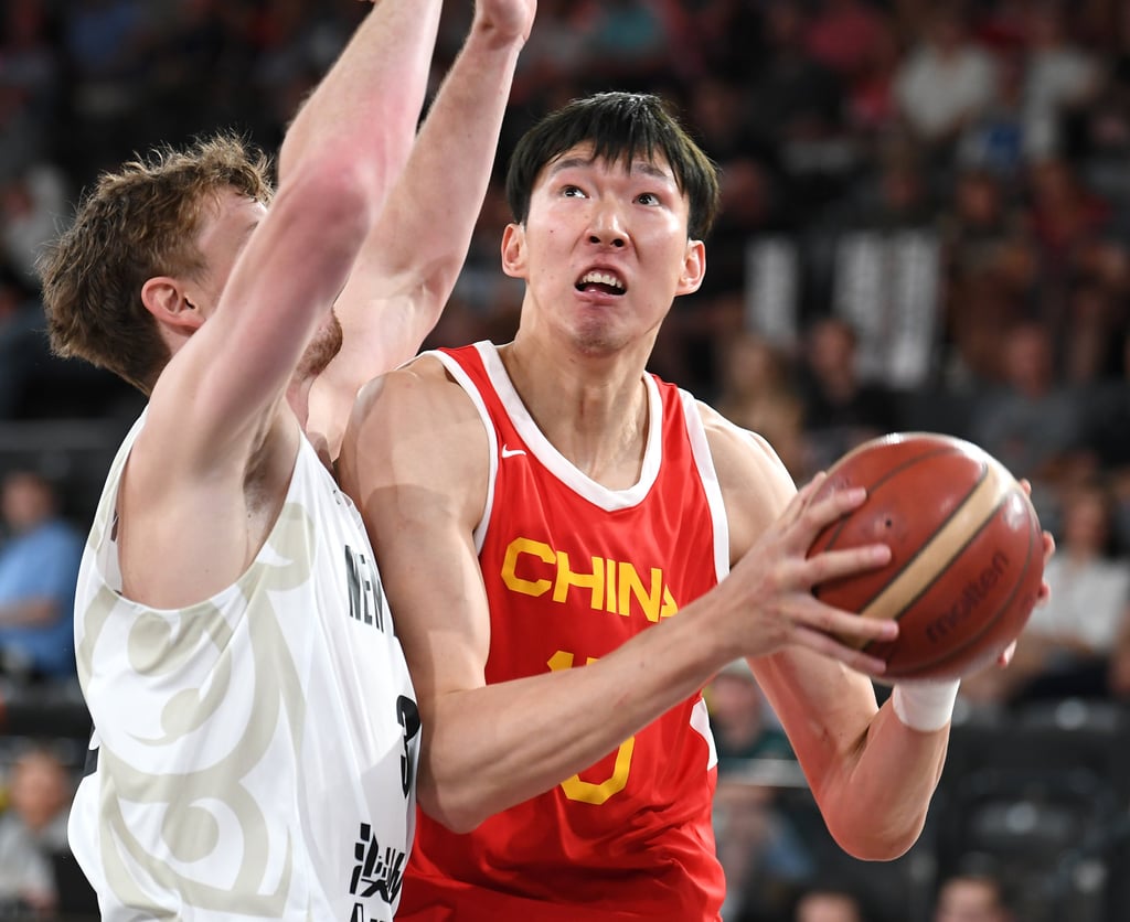 China’s Zhou Qi (right) drives to the basket during his side’s 69-68 win over New Zealand. Photo: Xinhua