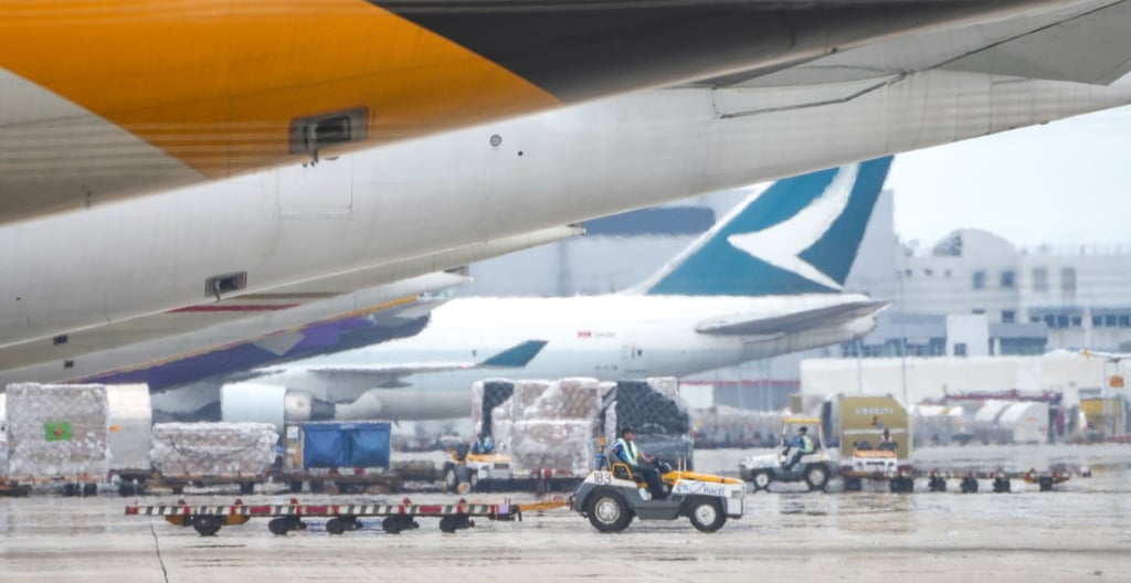 Workers on duty on the apron at the airport as planes load up or deliver cargo. Photo: Sam Tsang