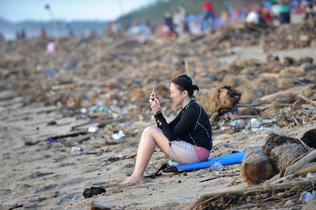 A tourist amid debris and rubbish washed up Kuta Beach, on Indonesia’s resort island of Bali, in 2019. Photo: AFP A tourist amid debris and rubbish washed up Kuta Beach, on Indonesia’s resort island of Bali, in 2019. Photo: AFP