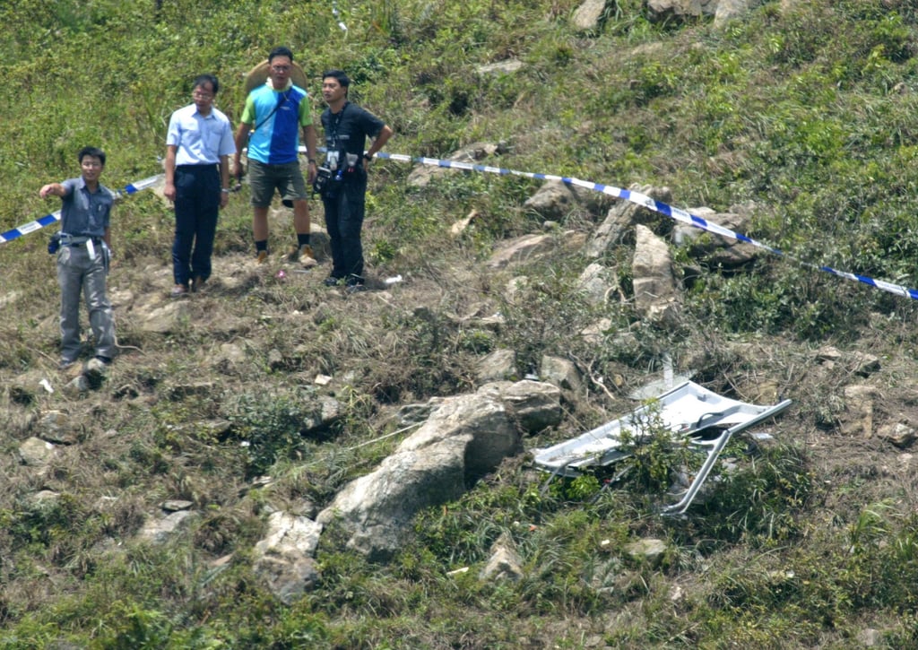 Investigators inspect parts of the wreckage of the Government Flying Service helicopter. Photo: SCMP