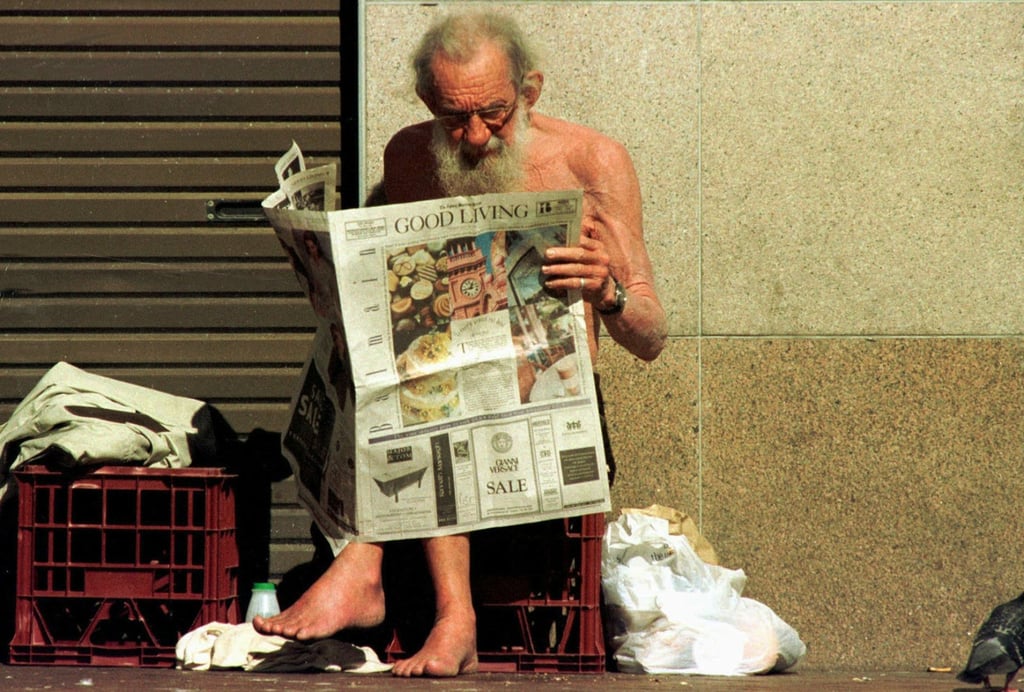 An elderly man reads a newspaper at Sydney’s Circular Quay. Australia’s aged-care economy could almost double to as much as 15 per cent of gross domestic product by the 2060s, according to a new report. Photo: Reuters