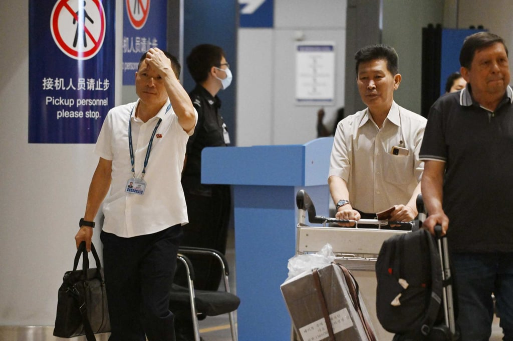 North Koreans make their way through the Beijing airport’s arrivals section after the Air Koryo flight landed. Photo: AFP North Koreans make their way through the Beijing airport’s arrivals section after the Air Koryo flight landed. Photo: AFP