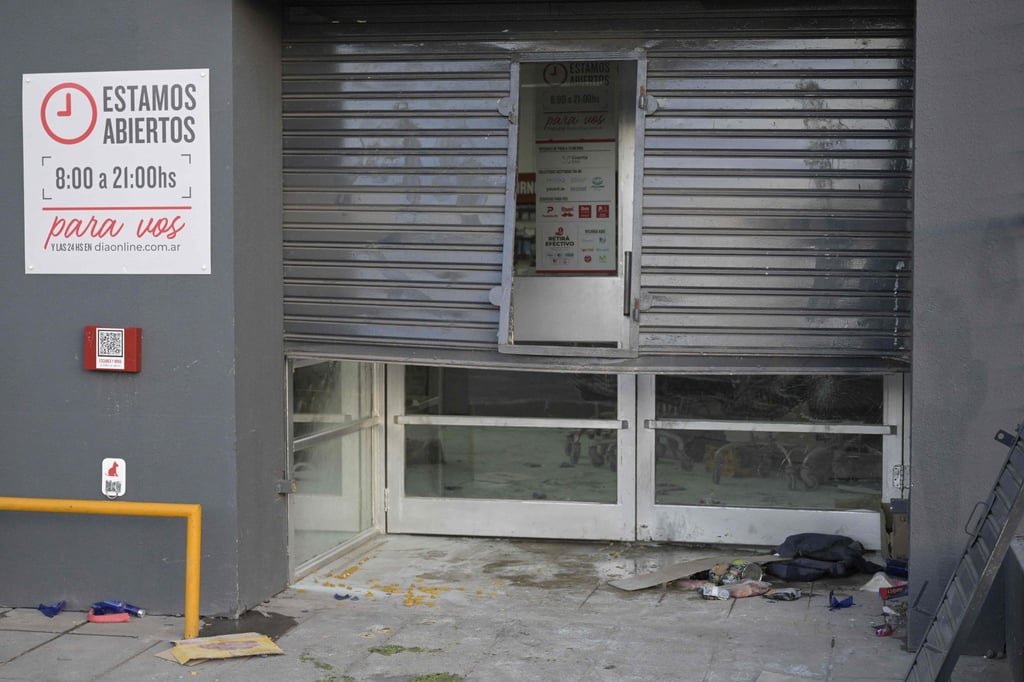 The door of a supermarket on the outskirts of Buenos Aires after it was looted. Photo: AFP