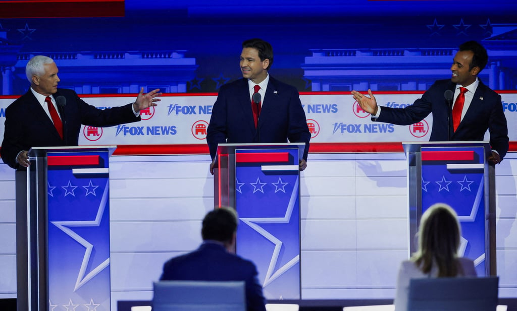 Former US vice-president Mike Pence and Vivek Ramaswamy debate each other across Florida Governor Ron DeSantis. Photo: Reuters