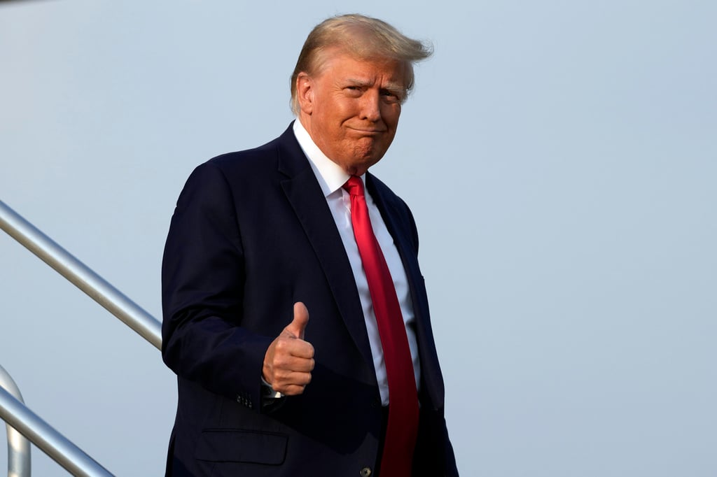 Donald Trump steps off his plane in Atlanta before heading to the Fulton County Jail. Photo: AP