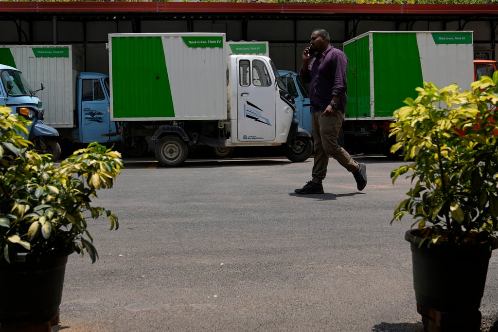 A man walks past electric rickshaws at a logistics company in Bangalore, India. The country is of the fastest growing electric vehicle markets in the world. Photo: AP A man walks past electric rickshaws at a logistics company in Bangalore, India. The country is of the fastest growing electric vehicle markets in the world. Photo: AP