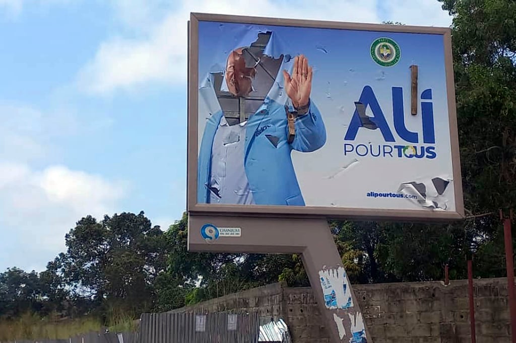 A defaced billboard of Gabon President Ali Bongo in Libreville, Gabon. Photo: AP