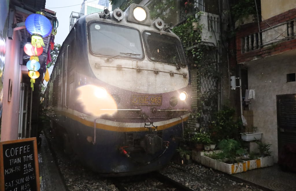 A train nuzzles its way down “Train Street”, a modern-day tourist attraction in Hanoi, Vietnam. Photo: Thomas Bird
