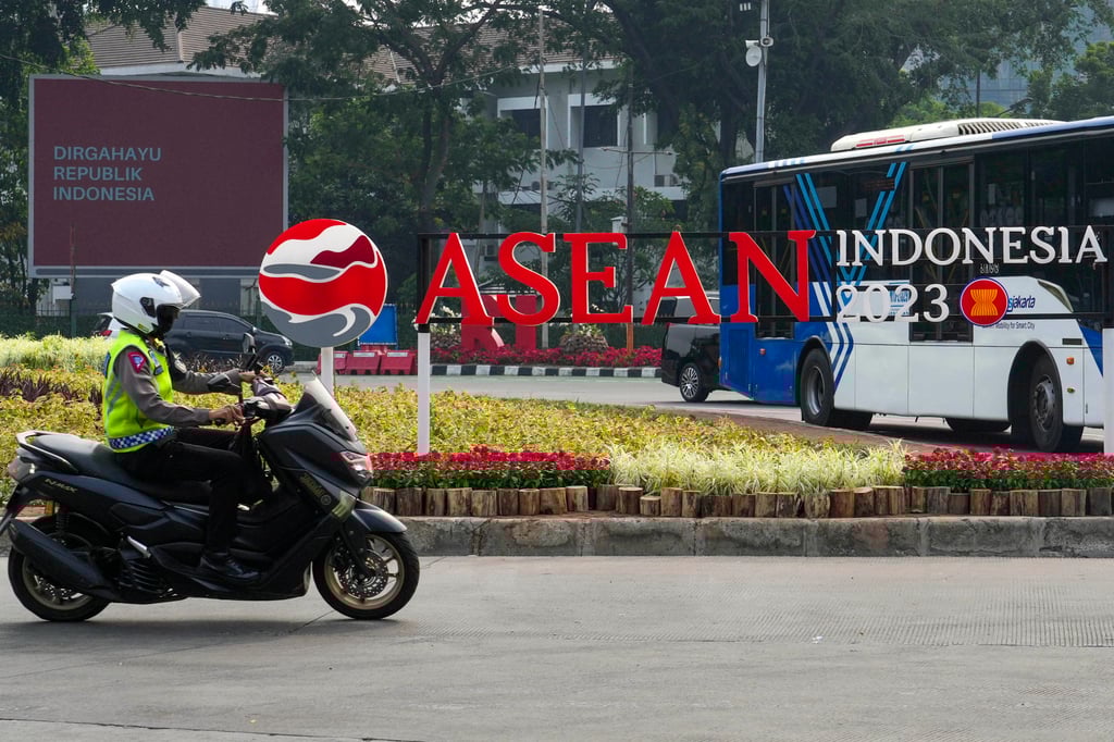 A policeman rides past an Asean summit logo in Jakarta. Photo: AP A policeman rides past an Asean summit logo in Jakarta. Photo: AP