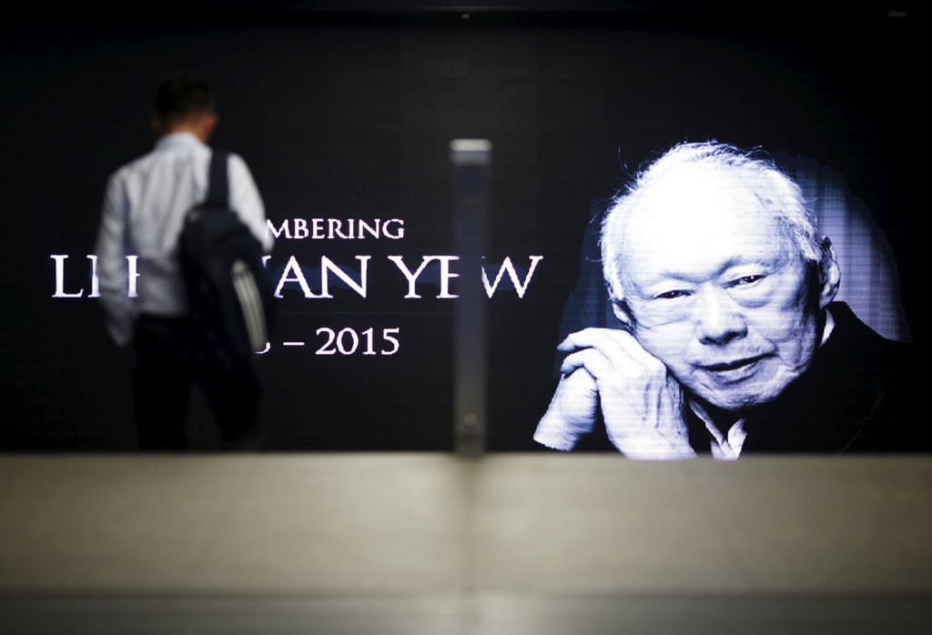 A commuter passes by a signboard bearing an image of the late first prime minister Lee Kuan Yew in a train station at the central business district in Singapore in March 2015. Photo: Reuters A commuter passes by a signboard bearing an image of the late first prime minister Lee Kuan Yew in a train station at the central business district in Singapore in March 2015. Photo: Reuters