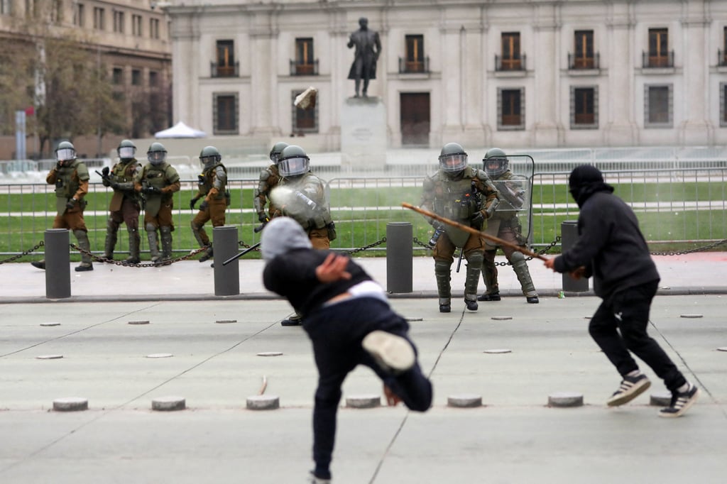 Demonstrators clash with riot police in Santiago, Chile. Photo: Reuters