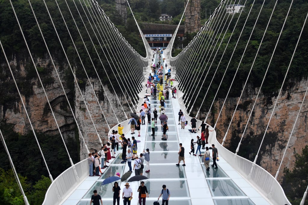 Zhangjiajie has a massive glass bridge that allows you to see the scenery below your feet. Photo: Xinhua Zhangjiajie has a massive glass bridge that allows you to see the scenery below your feet. Photo: Xinhua