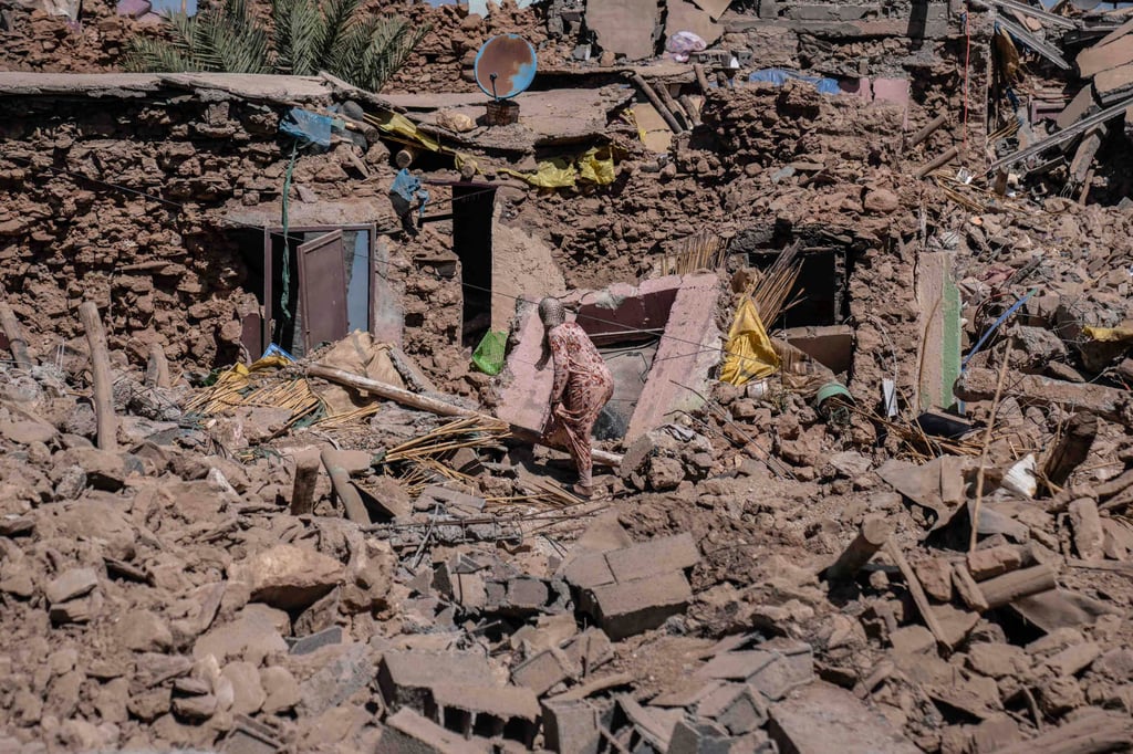 A woman tries to recover some of her possessions from her home in the village of Tafeghaghte, near Marrakech, Morocco. Photo: AP A woman tries to recover some of her possessions from her home in the village of Tafeghaghte, near Marrakech, Morocco. Photo: AP