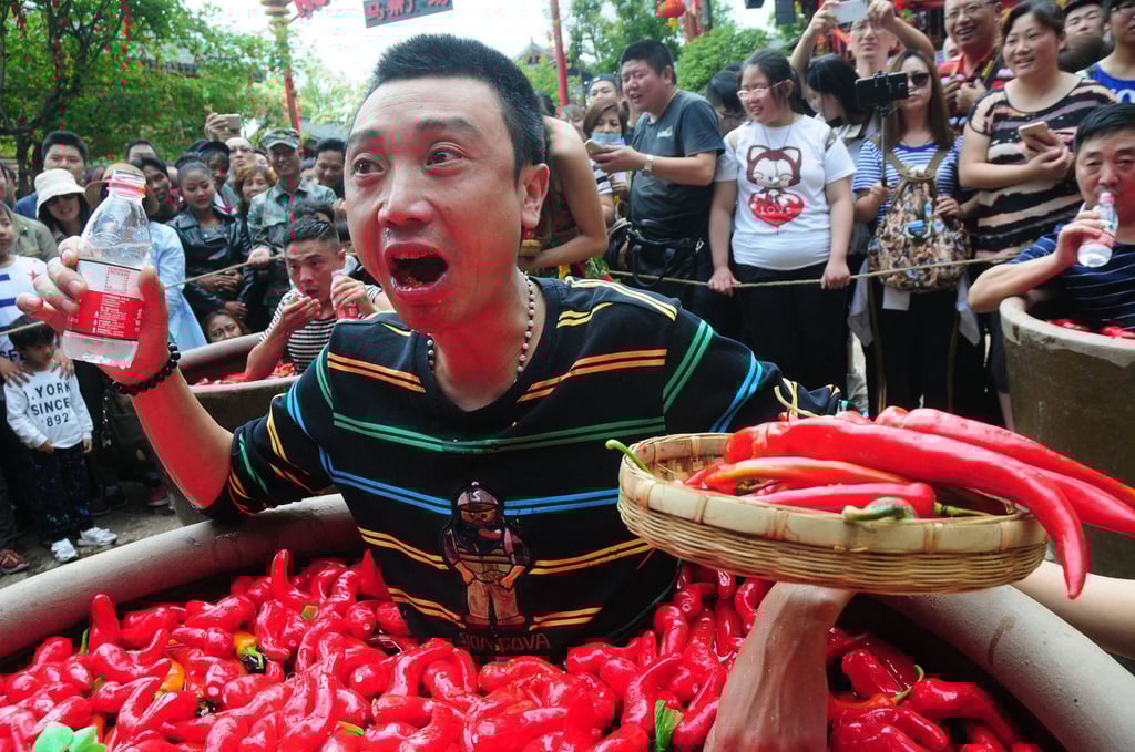 A man from Chengdu takes part in a chill- pepper-eating competition in Lijiang, in China’s Yunnan province, in 2016. Photo: AFP A man from Chengdu takes part in a chill- pepper-eating competition in Lijiang, in China’s Yunnan province, in 2016. Photo: AFP
