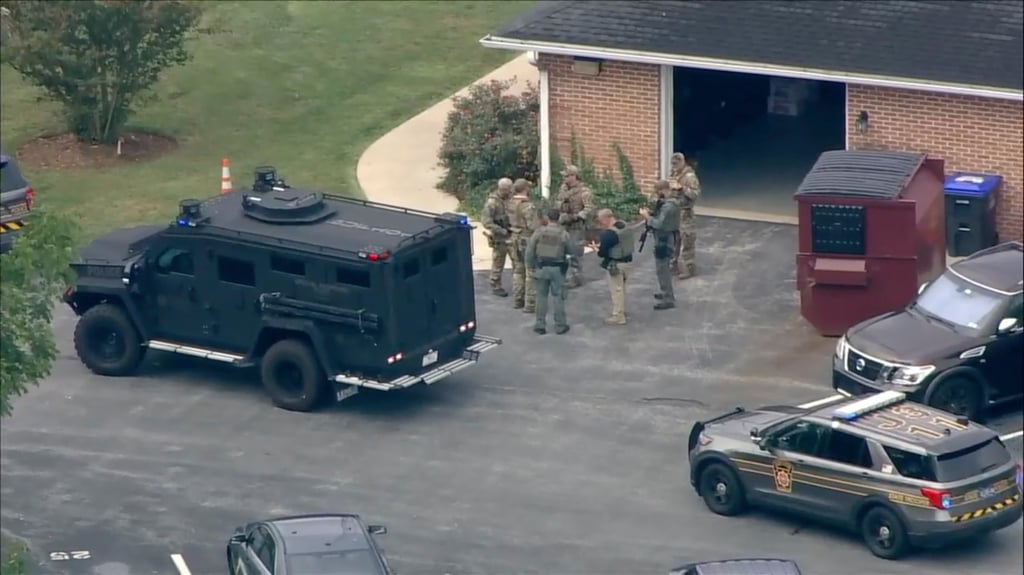 Law enforcement agents stand by an armoured vehicle with Danelo Cavalcante inside at the Pennsylvania State Police barracks. Photo: WPI via AP Law enforcement agents stand by an armoured vehicle with Danelo Cavalcante inside at the Pennsylvania State Police barracks. Photo: WPI via AP