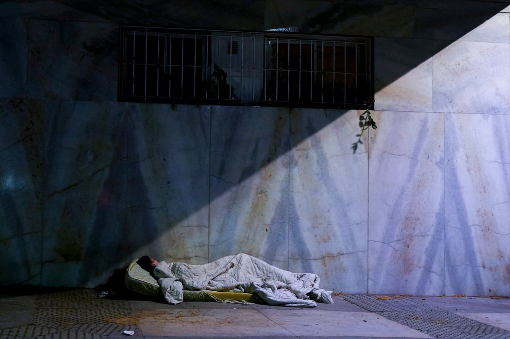 A homeless person sleeps on the pavement in Buenos Aires, Argentina. Photo: AP A homeless person sleeps on the pavement in Buenos Aires, Argentina. Photo: AP